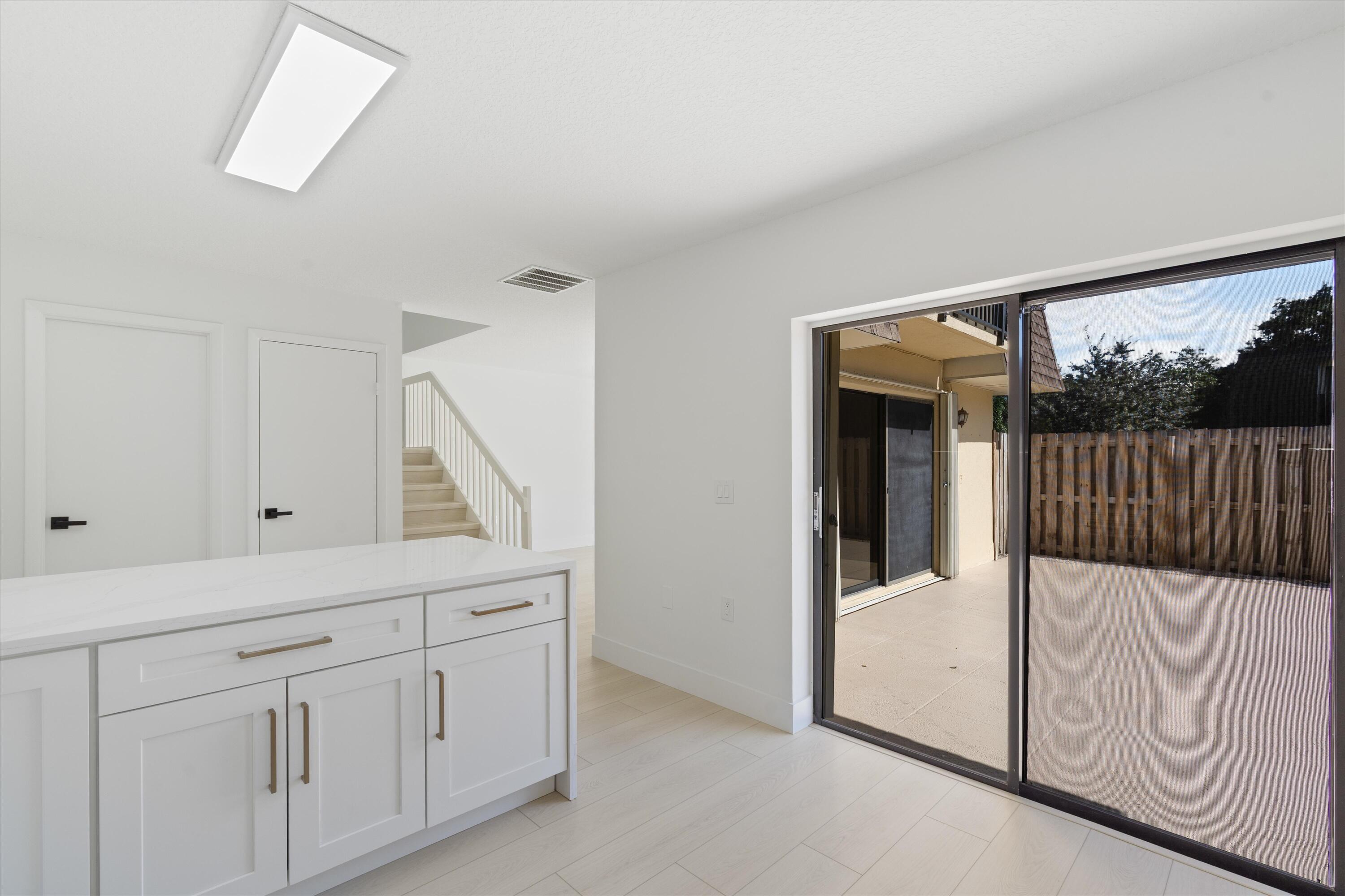2897 Southwest 22nd Circle, Unit 44B Delray Beach, FL 33445 - Photo 7 of 31 a view of a hallway to a bedroom and with furniture
