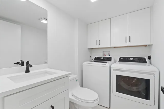 a bathroom with a sink a toilet and a mirror
