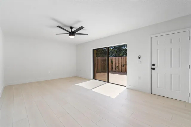 a view of a livingroom with a ceiling fan and window