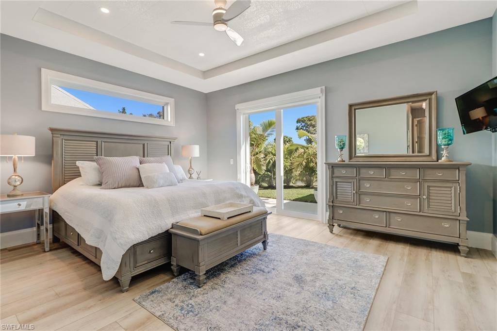 5130 Alpha Court Naples, FL 34105 - Photo 12 of 35 a spacious bedroom with a bed and a dresser
