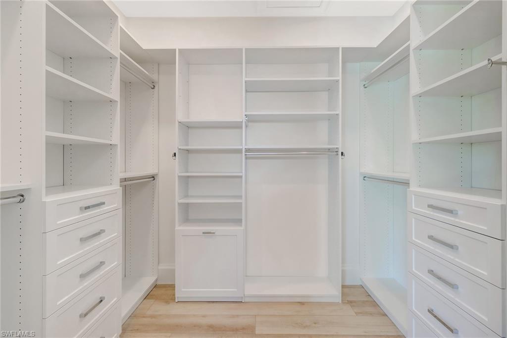5130 Alpha Court Naples, FL 34105 - Photo 15 of 35 a view of walk in closet with empty racks