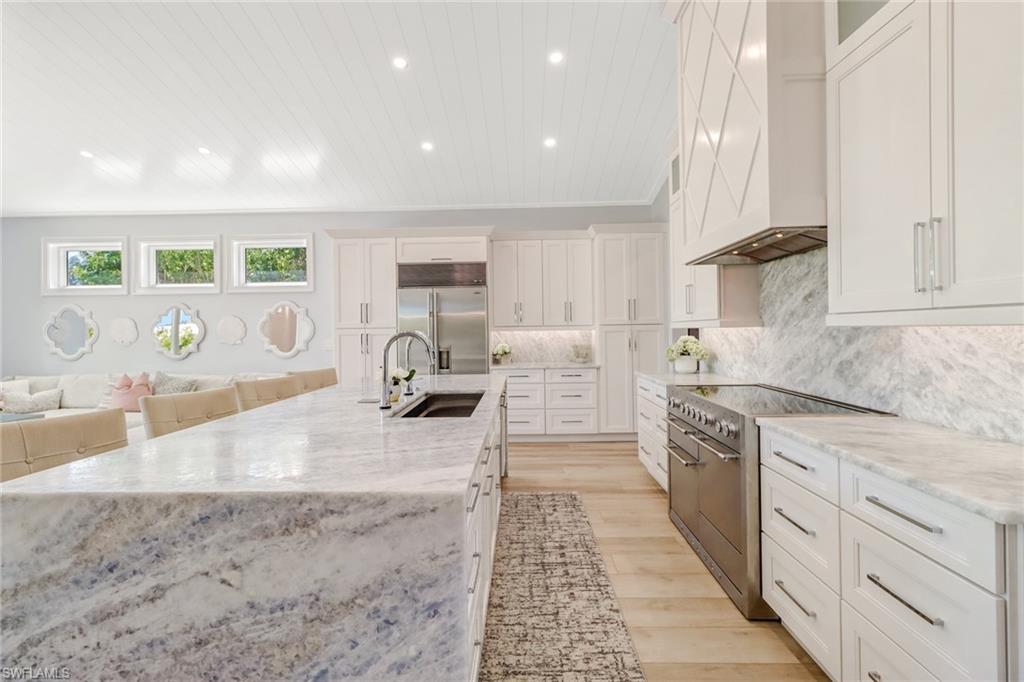 5130 Alpha Court Naples, FL 34105 - Photo 2 of 35 a large kitchen with stainless steel appliances granite countertop a lot of counter space and a sink