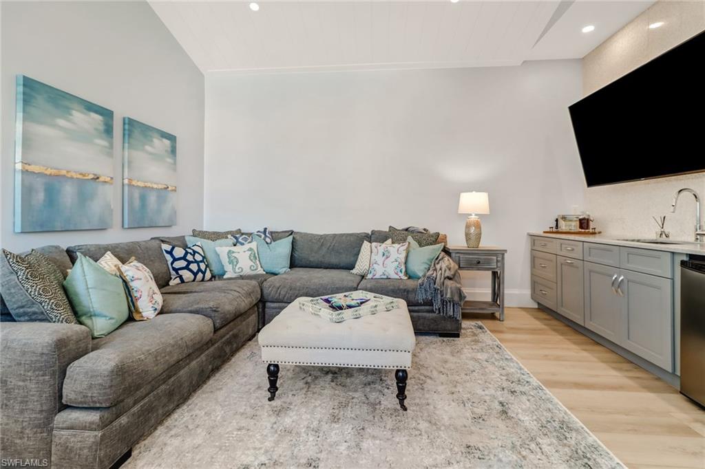 5130 Alpha Court Naples, FL 34105 - Photo 21 of 35 a living room with furniture and a flat screen tv