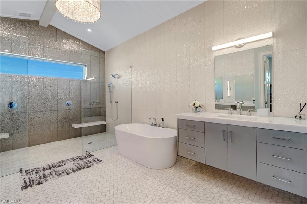 5130 Alpha Court Naples, FL 34105 - Photo 24 of 35 a spacious bathroom with a double vanity sink mirror and a bathtub
