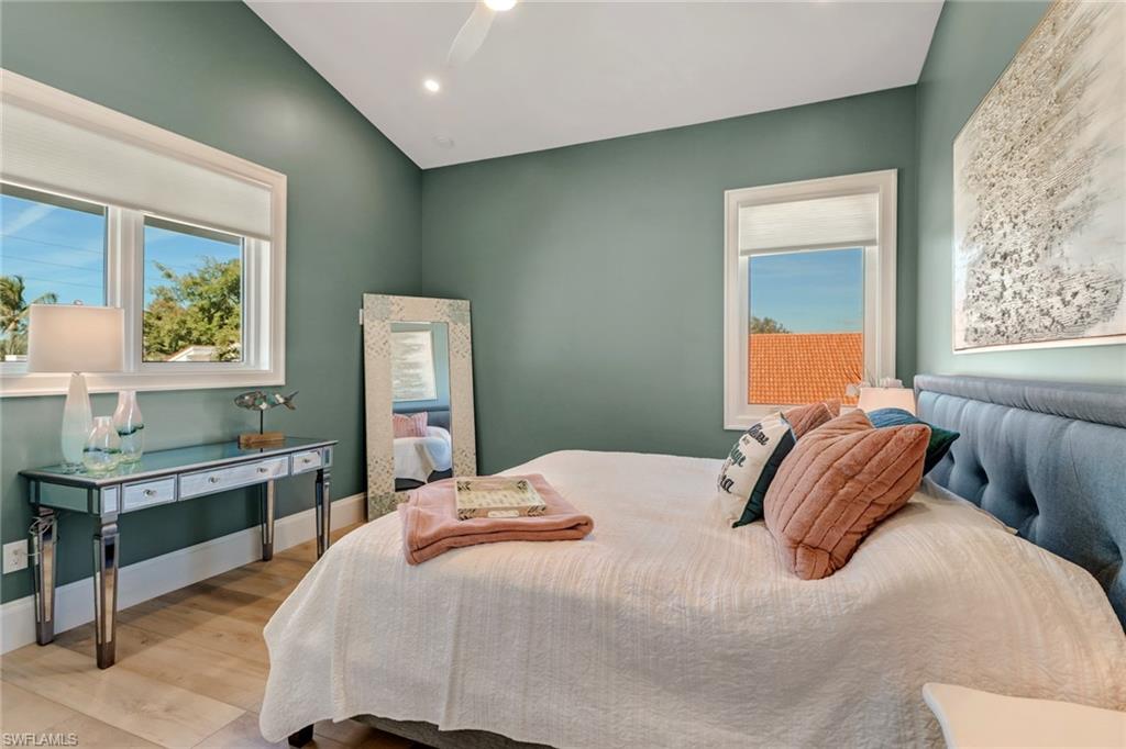 5130 Alpha Court Naples, FL 34105 - Photo 25 of 35 a bedroom with a bed and a table in it