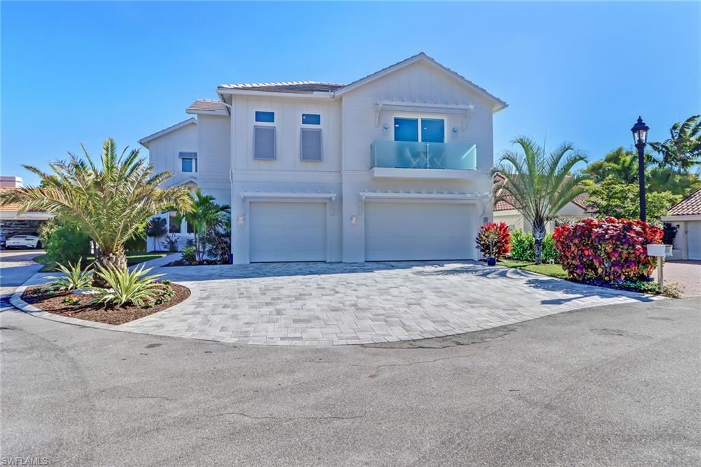 5130 Alpha Court Naples, FL 34105 - Photo 28 of 35 a front view of a house with a yard