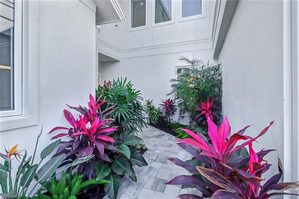 5130 Alpha Court Naples, FL 34105 - Photo 30 of 35 a view of a house with a flower garden