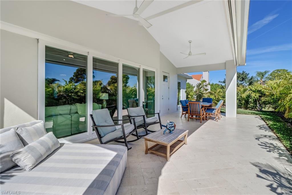 5130 Alpha Court Naples, FL 34105 - Photo 34 of 35 a building outdoor space with patio furniture and potted plants