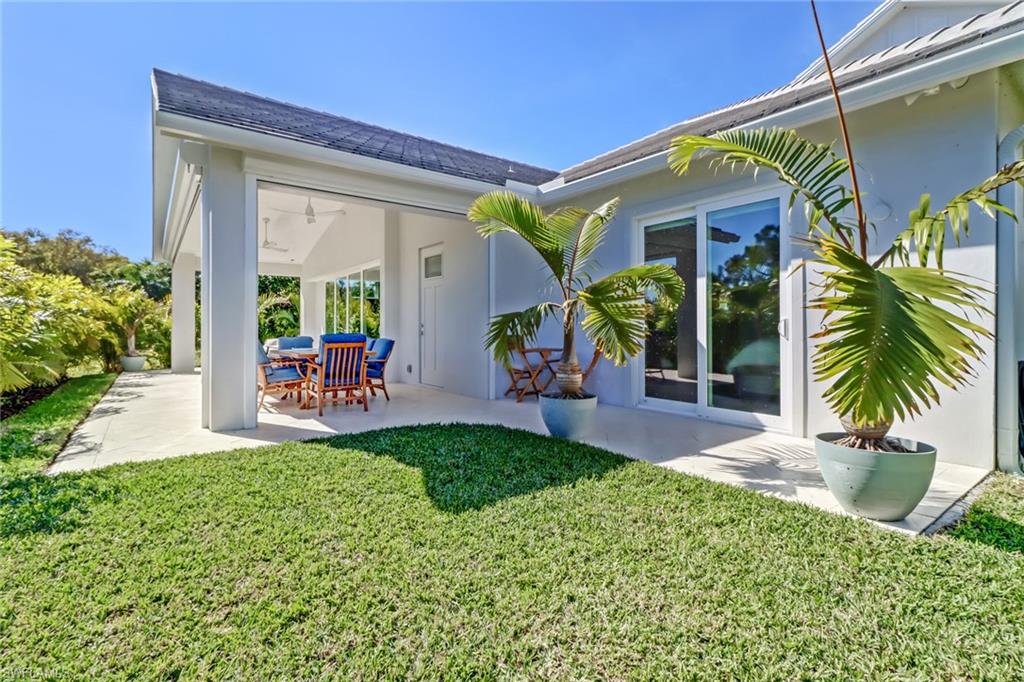 5130 Alpha Court Naples, FL 34105 - Photo 35 of 35 a view of a porch with chairs and potted plants