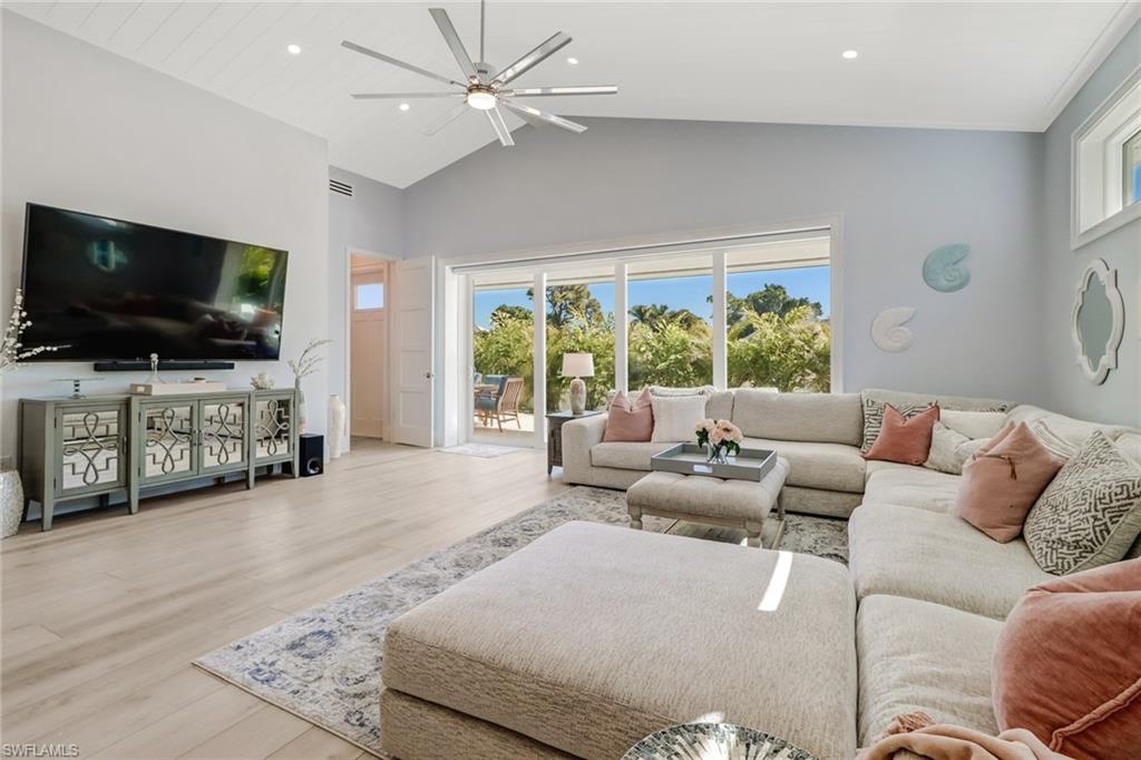 5130 Alpha Court Naples, FL 34105 - Photo 10 of 35 a living room with furniture and a flat screen tv