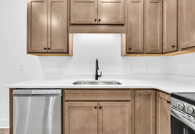 a kitchen with a sink and cabinets
