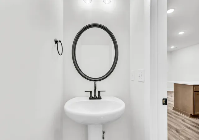 a bathroom with a sink a mirror and a shower