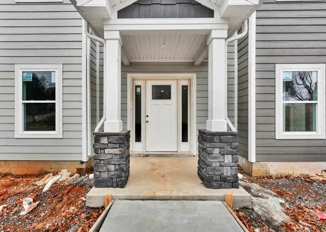 a front view of a house with large windows