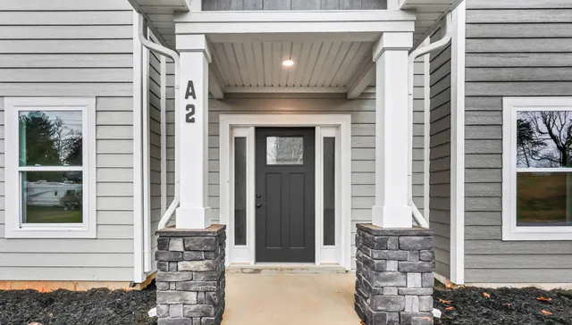 a front view of a house with large windows