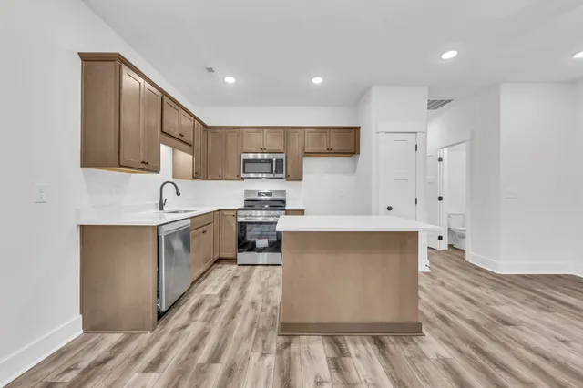 a kitchen with white cabinets and white appliances