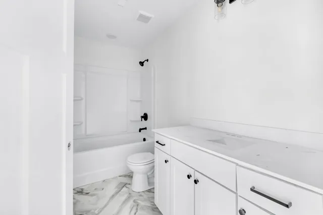 a bathroom with a sink a toilet and bathtub