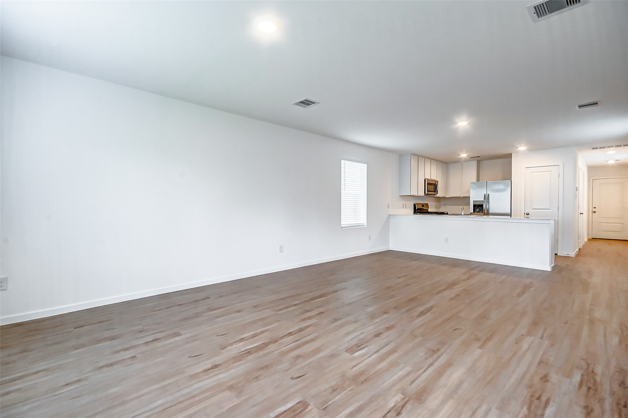21535 Carosella Drive New Caney, TX 77357 - Photo 12 of 25 a view of a kitchen with wooden floor and a window
