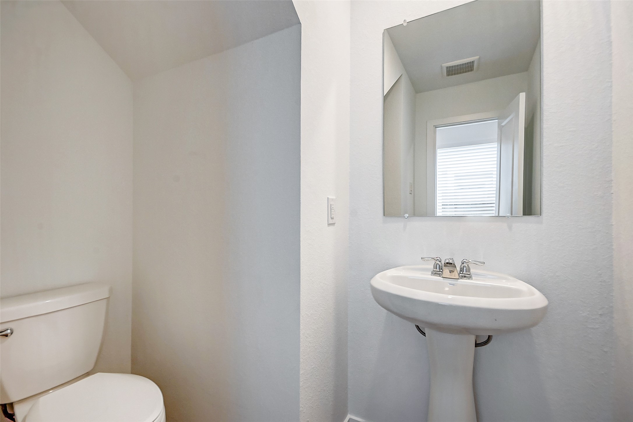 21535 Carosella Drive New Caney, TX 77357 - Photo 13 of 25 a bathroom with a toilet sink and mirror