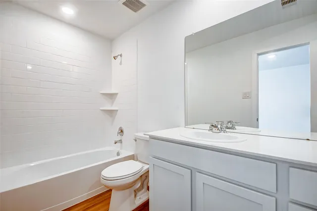 a bathroom with a sink toilet and mirror