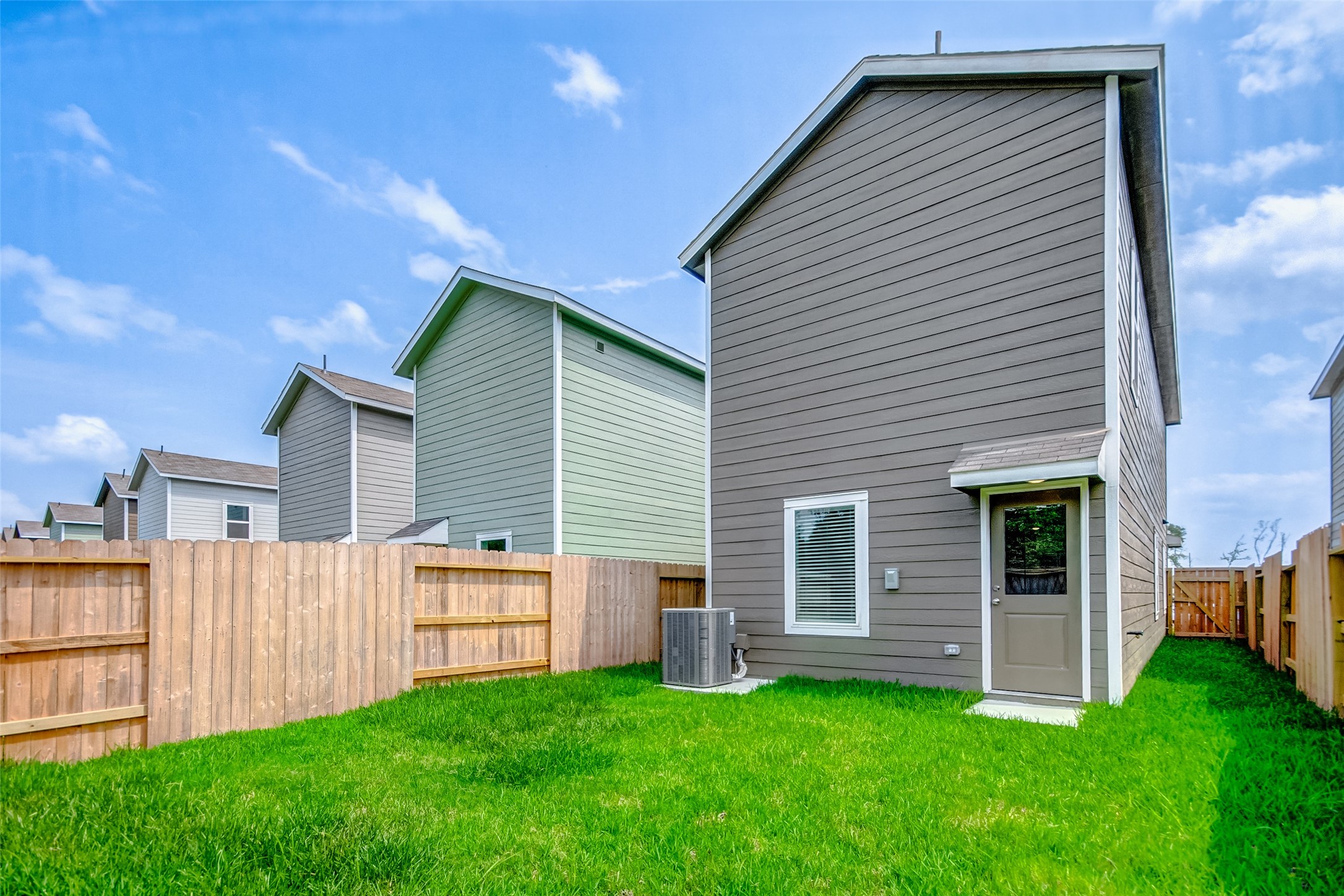 21535 Carosella Drive New Caney, TX 77357 - Photo 23 of 25 a backyard of a house with plants and large tree