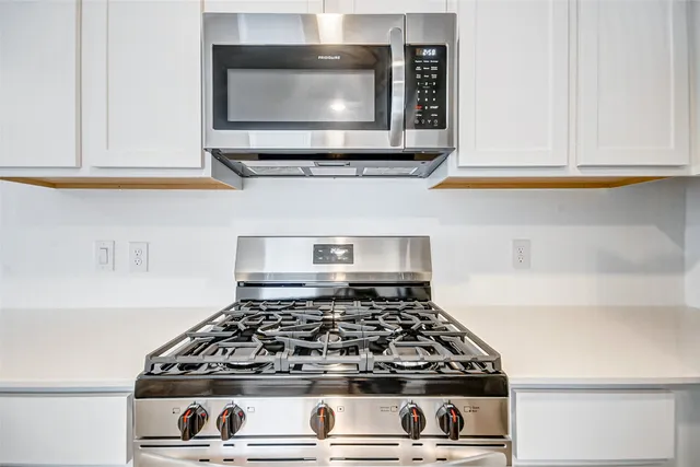 a stove top oven sitting inside of a kitchen