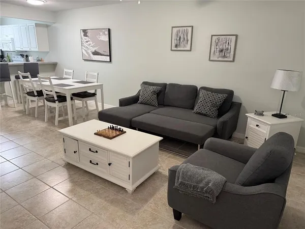 a living room with furniture and a work place