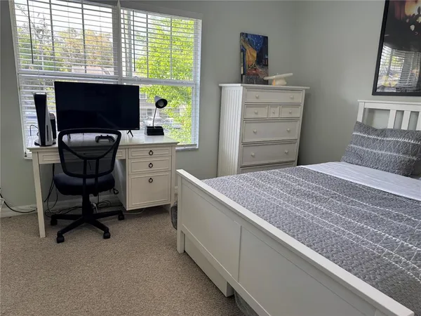 a bedroom with a workspace
