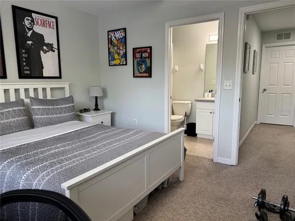 a bedroom with a bed and a couch