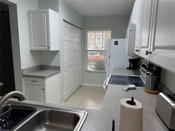 a kitchen with sink and cabinets