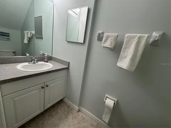 a bathroom with a sink and mirror