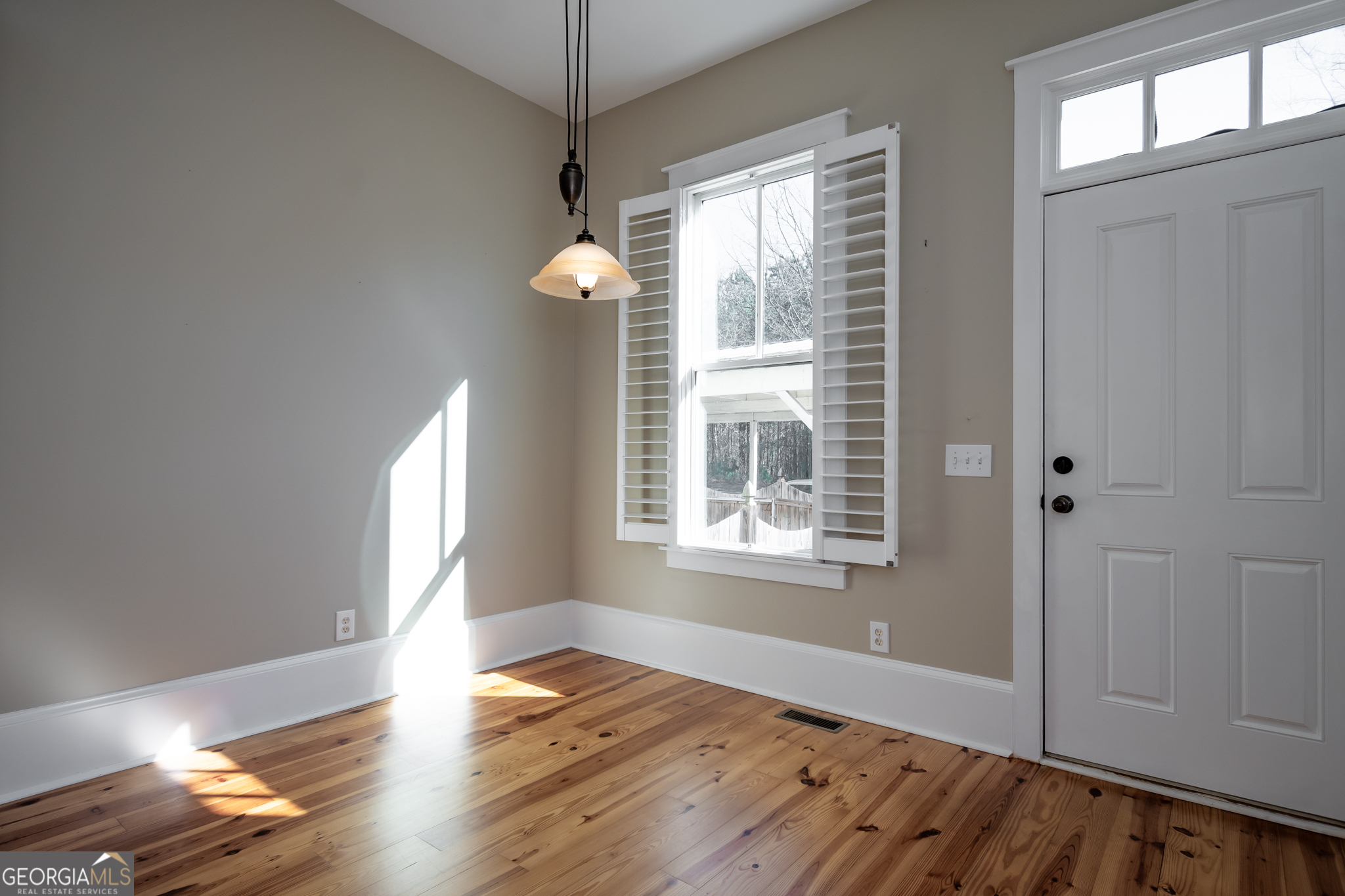 83 Charter Oak Drive Athens, GA 30607 - Photo 11 of 46 an empty room with wooden floor fan and windows