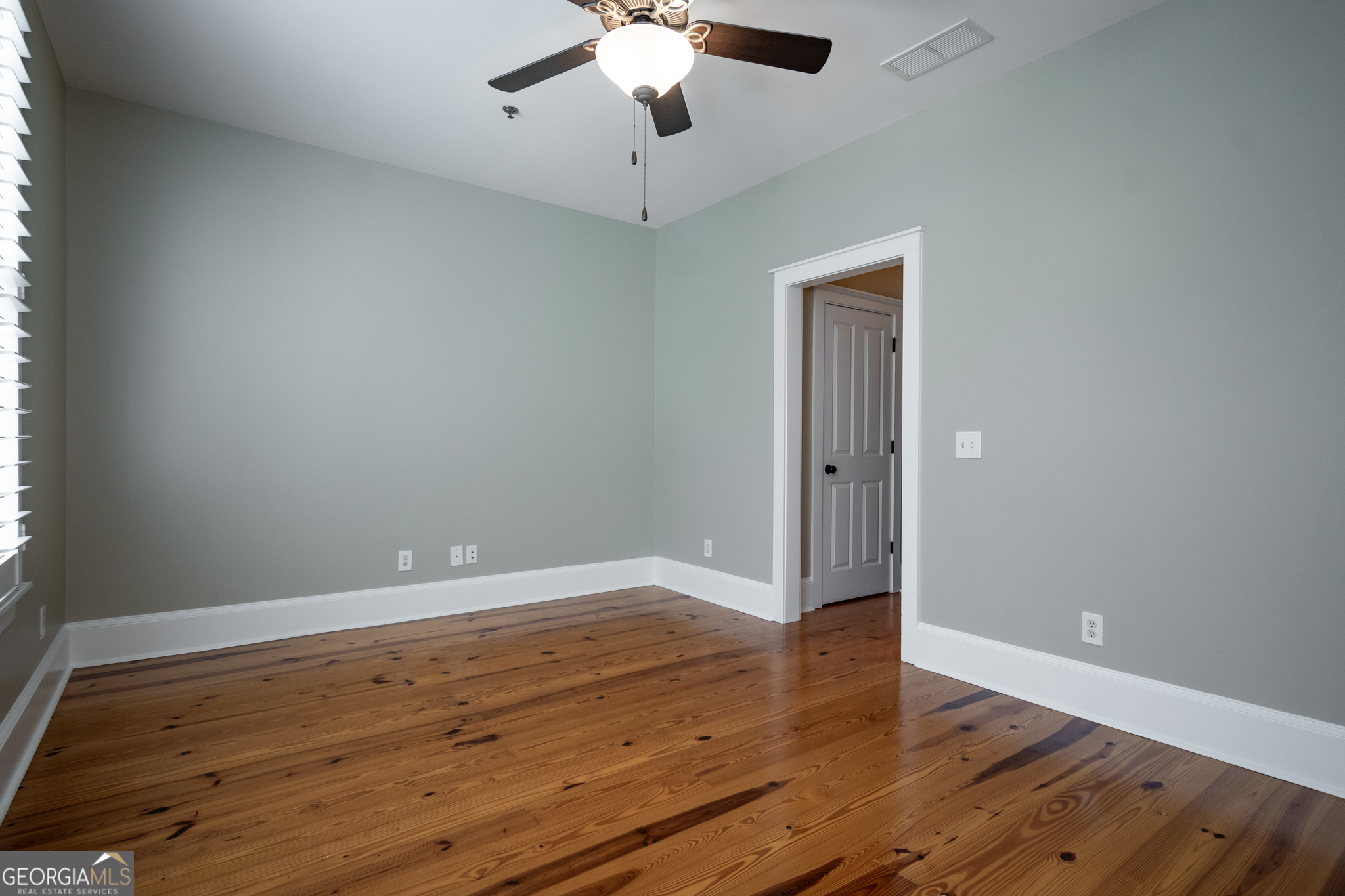 83 Charter Oak Drive Athens, GA 30607 - Photo 23 of 46 an empty room with wooden floor chandelier fan and windows