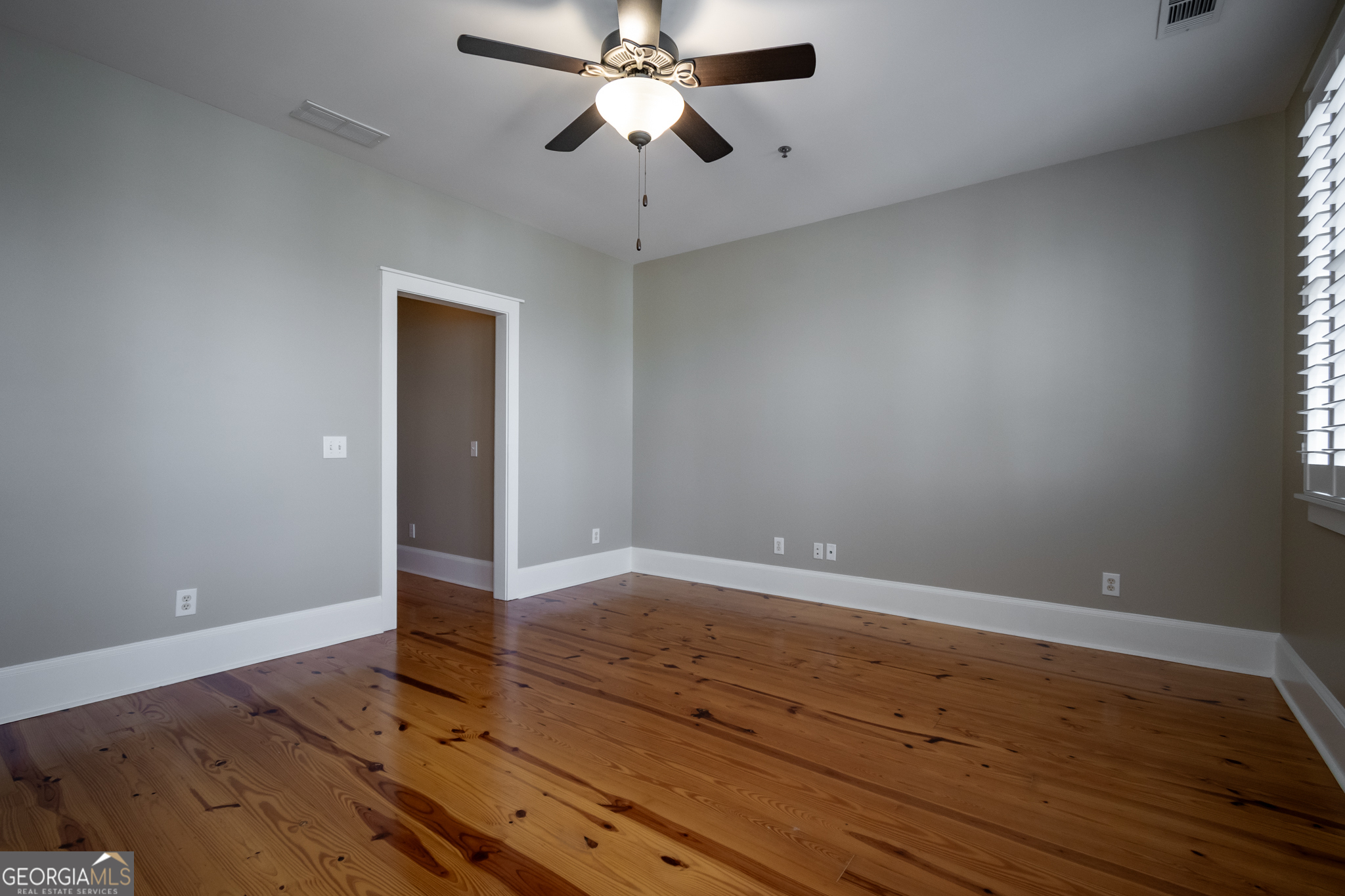 83 Charter Oak Drive Athens, GA 30607 - Photo 30 of 46 an empty room with wooden floor chandelier fan and windows