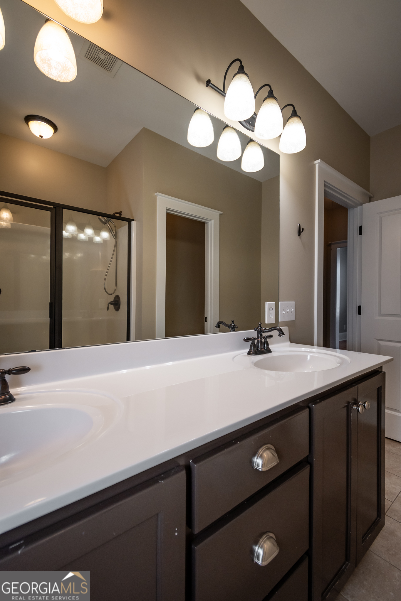 83 Charter Oak Drive Athens, GA 30607 - Photo 35 of 46 a bathroom with a sink a large mirror and a light fixture