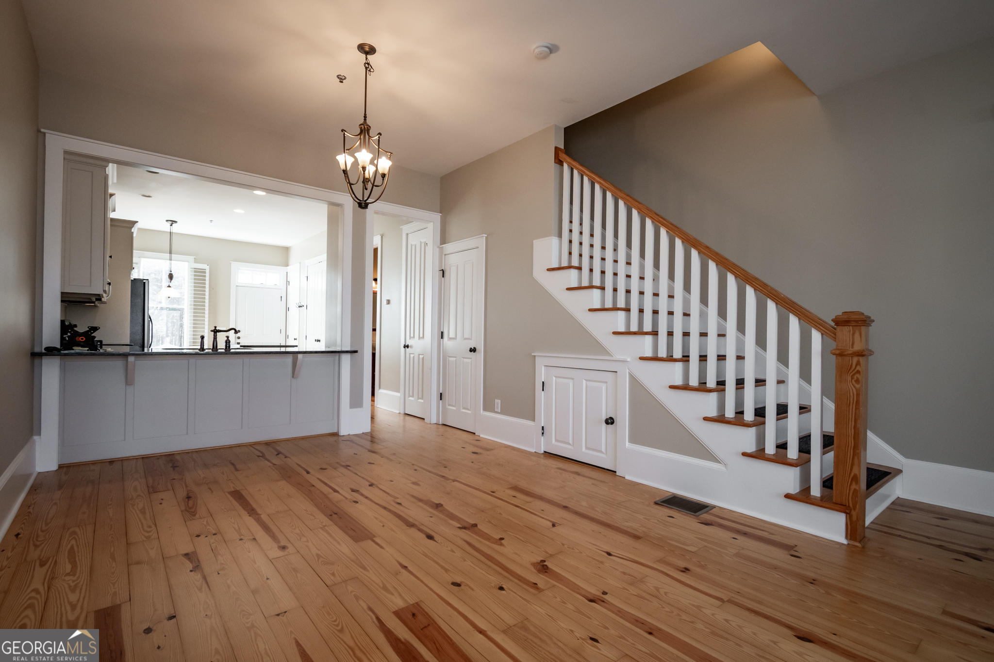 83 Charter Oak Drive Athens, GA 30607 - Photo 5 of 46 a view of an entryway with wooden floor and a kitchen