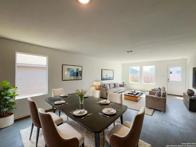 a dining room with wooden floor a glass table and chairs