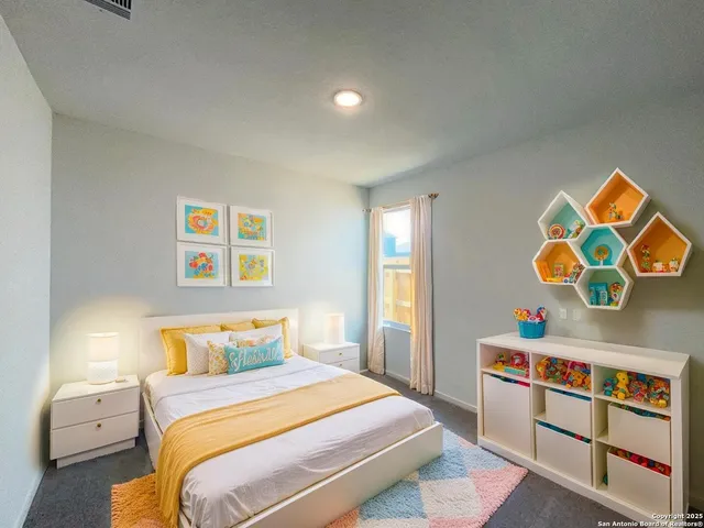 a bedroom with a bed and cabinets