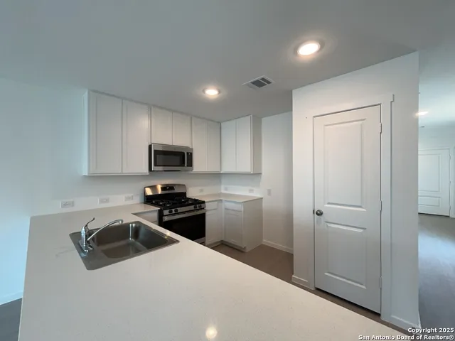 a kitchen with a sink a stove and refrigerator