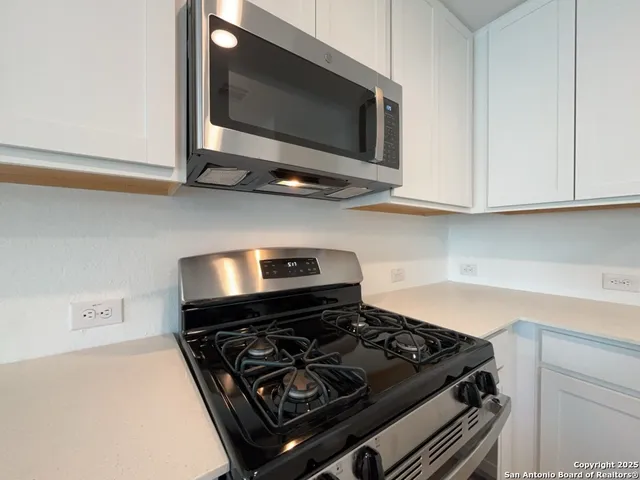 a stove top oven sitting inside of a kitchen