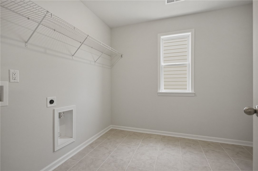 557 Hydrangea Street, Unit LOT 46 Seneca, SC 29678 - Photo 21 of 37 A well-lit utility space provides ample room and durable flooring for household tasks.