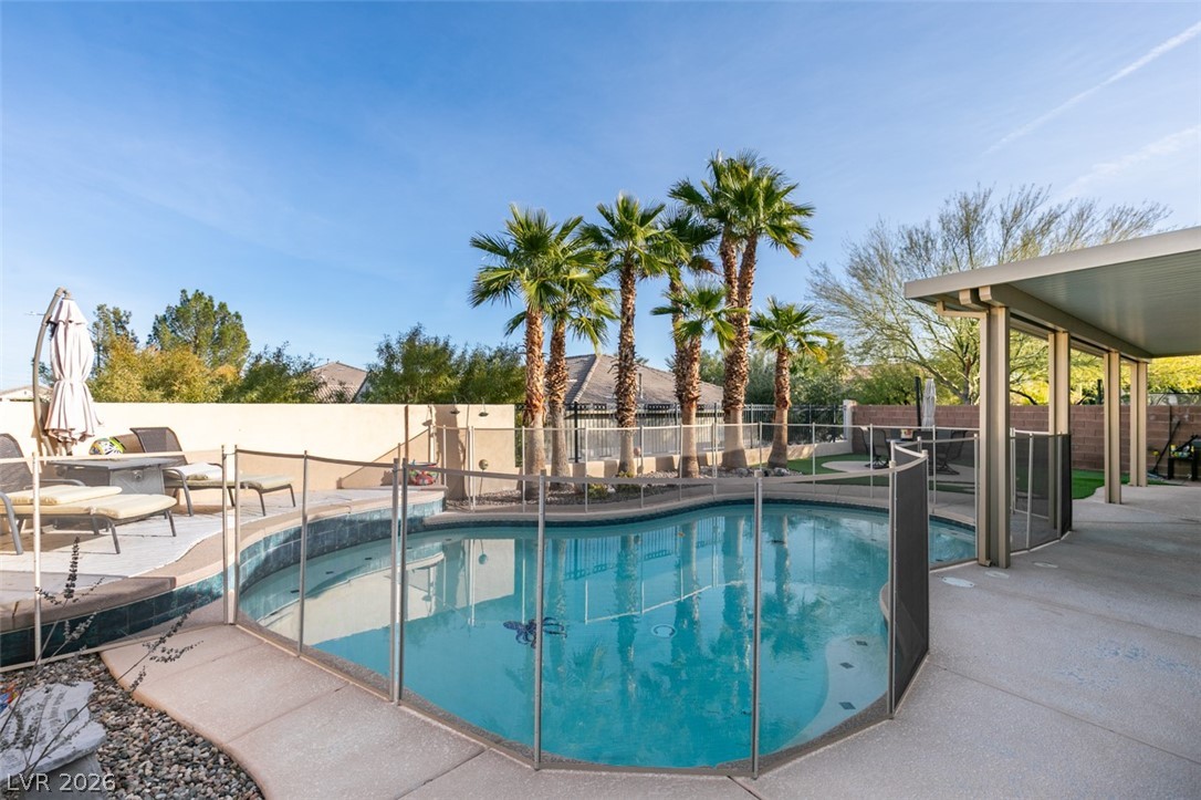 7524 Midnight Rambler Street Las Vegas, NV 89149 - Photo 45 of 51 An inviting backyard oasis offers a sparkling pool and a covered patio for ultimate relaxation.