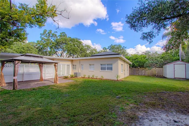 a view of backyard with a patio