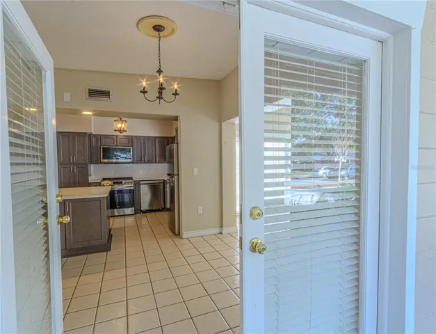 a view of kitchen with sink refrigerator and cabinets