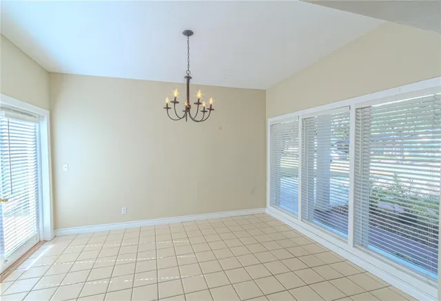 a view of an empty room with glass door