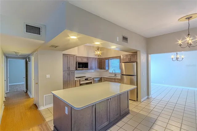 a kitchen with a sink counter top space and stainless steel appliances