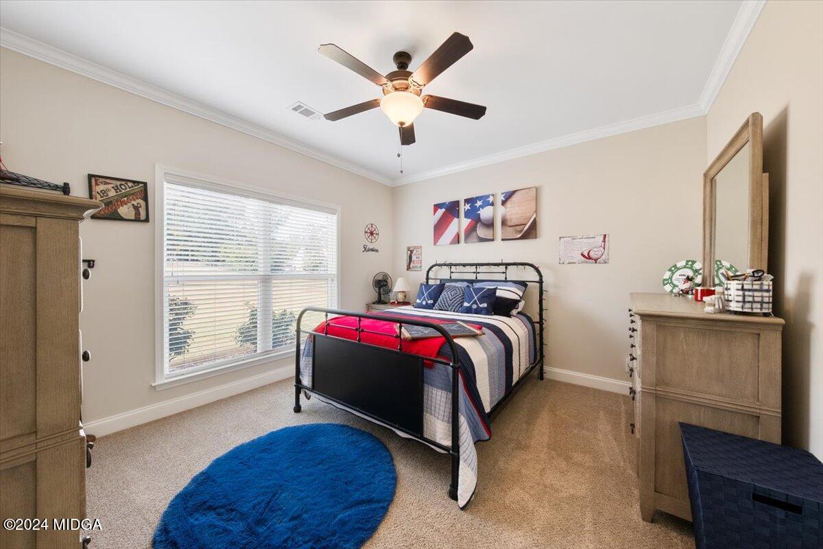 155 Carters Way Forsyth, GA 31029 - Photo 12 of 28 a bedroom with a bed and a large window with the outer view
