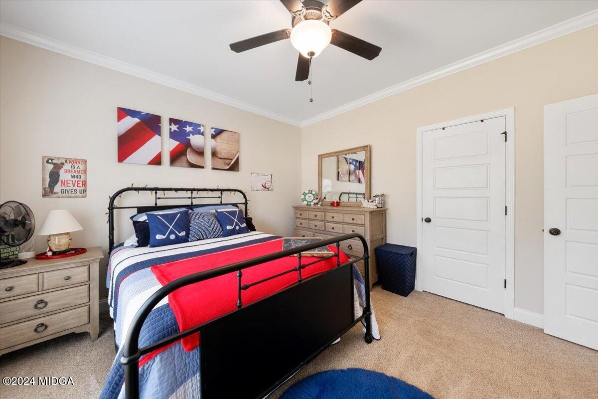 155 Carters Way Forsyth, GA 31029 - Photo 13 of 28 a bedroom with a bed and a chandelier