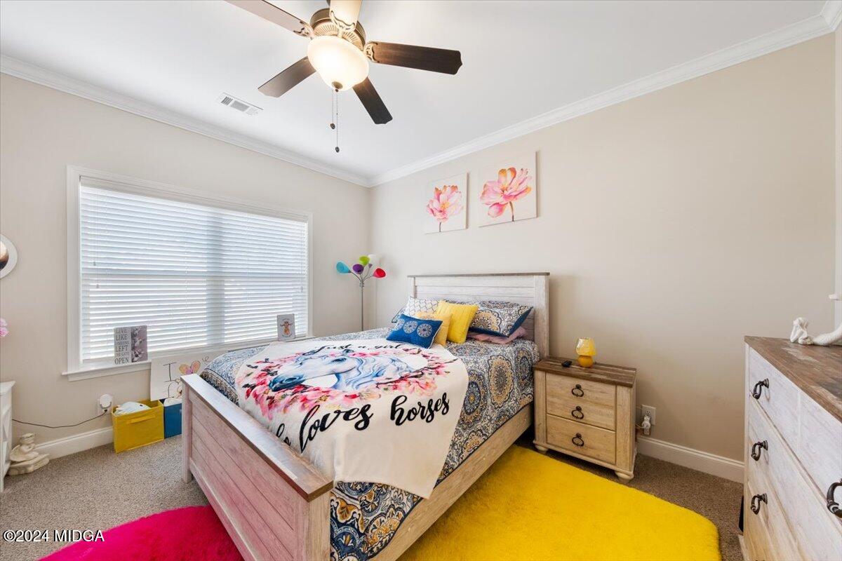 155 Carters Way Forsyth, GA 31029 - Photo 14 of 28 a bed room with a bed and a window