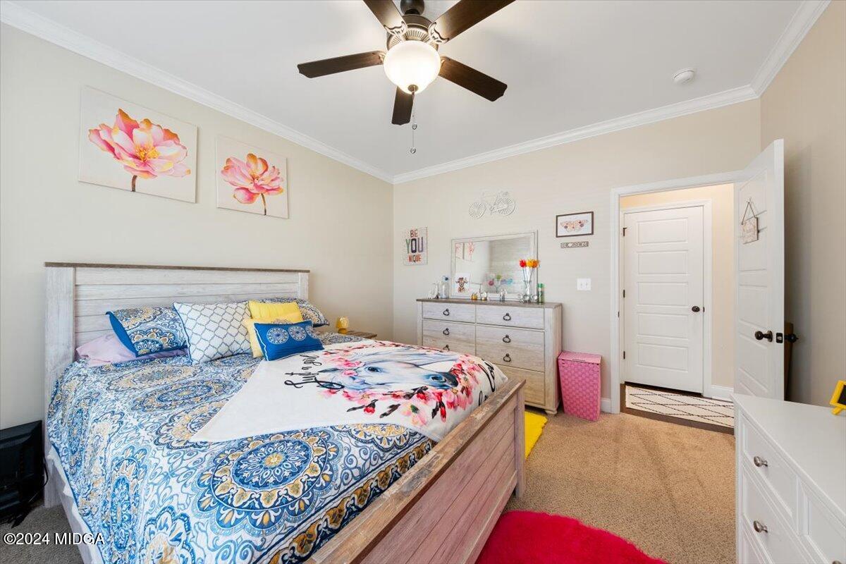 155 Carters Way Forsyth, GA 31029 - Photo 15 of 28 a bedroom with a bed and a chandelier