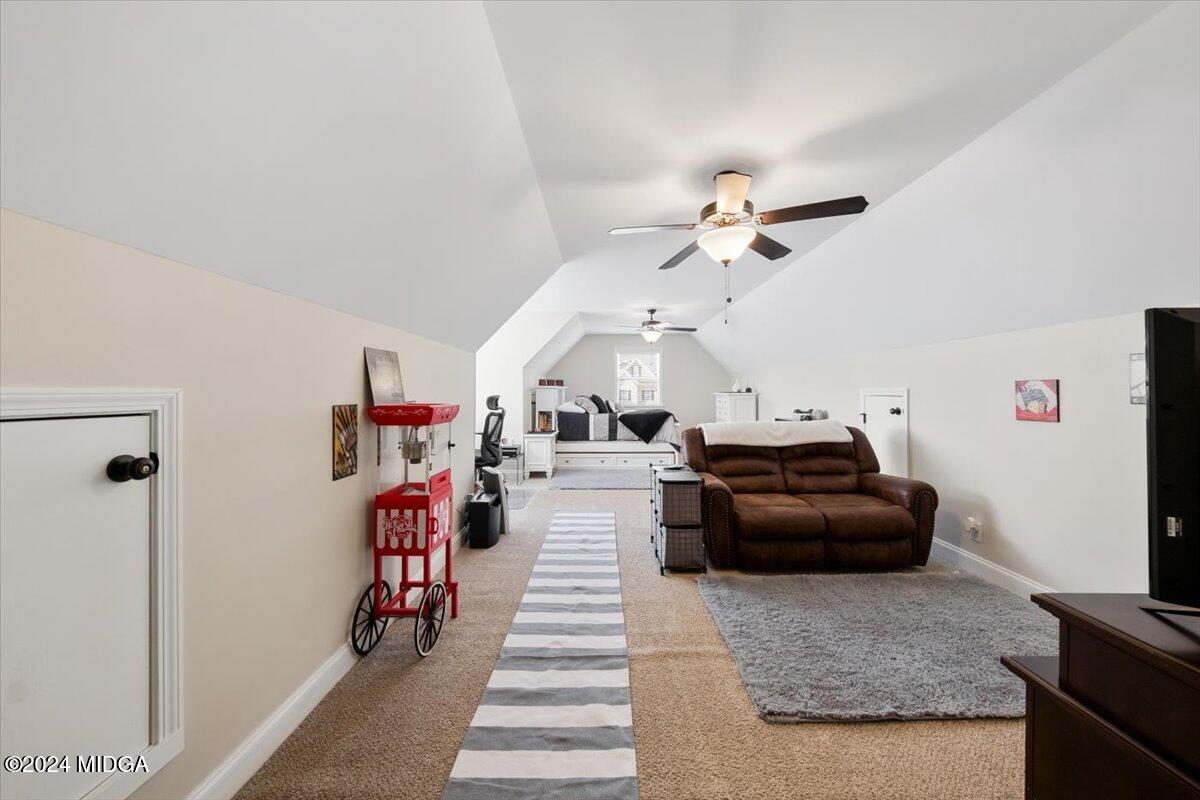 155 Carters Way Forsyth, GA 31029 - Photo 17 of 28 a living room with furniture and a chandelier